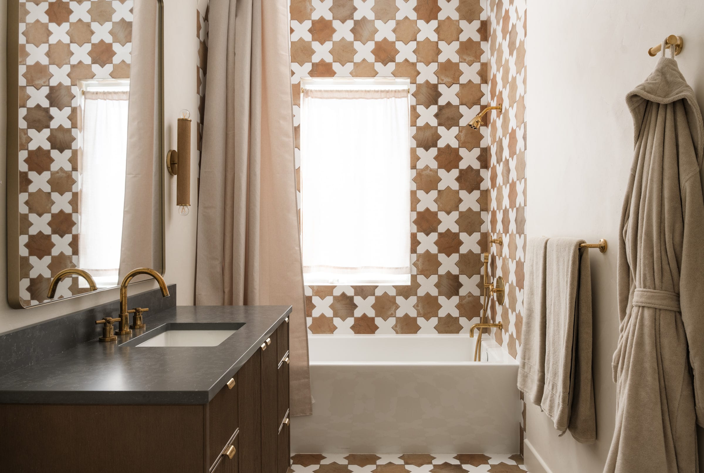 Bathroom with patterned terracotta and white cross tile walls, a soaking tub, and brass fixtures, DHRH Mission Canyon renovation