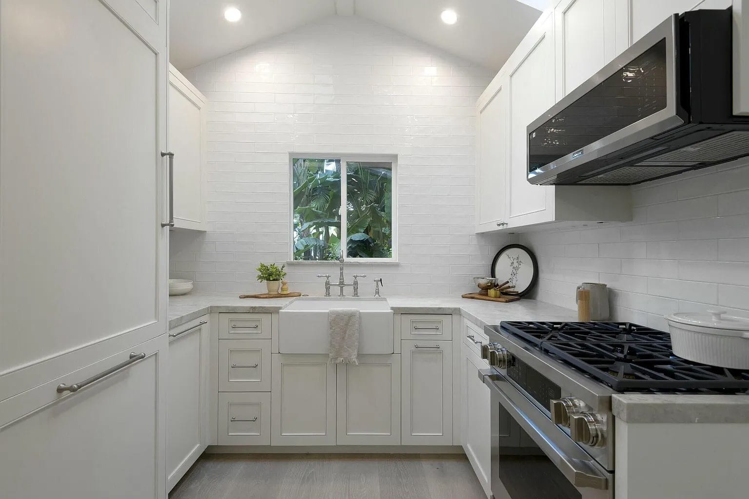 Compact guest house kitchen with white subway tile, a farmhouse sink, and a vaulted ceiling, DHRH Montecito renovation