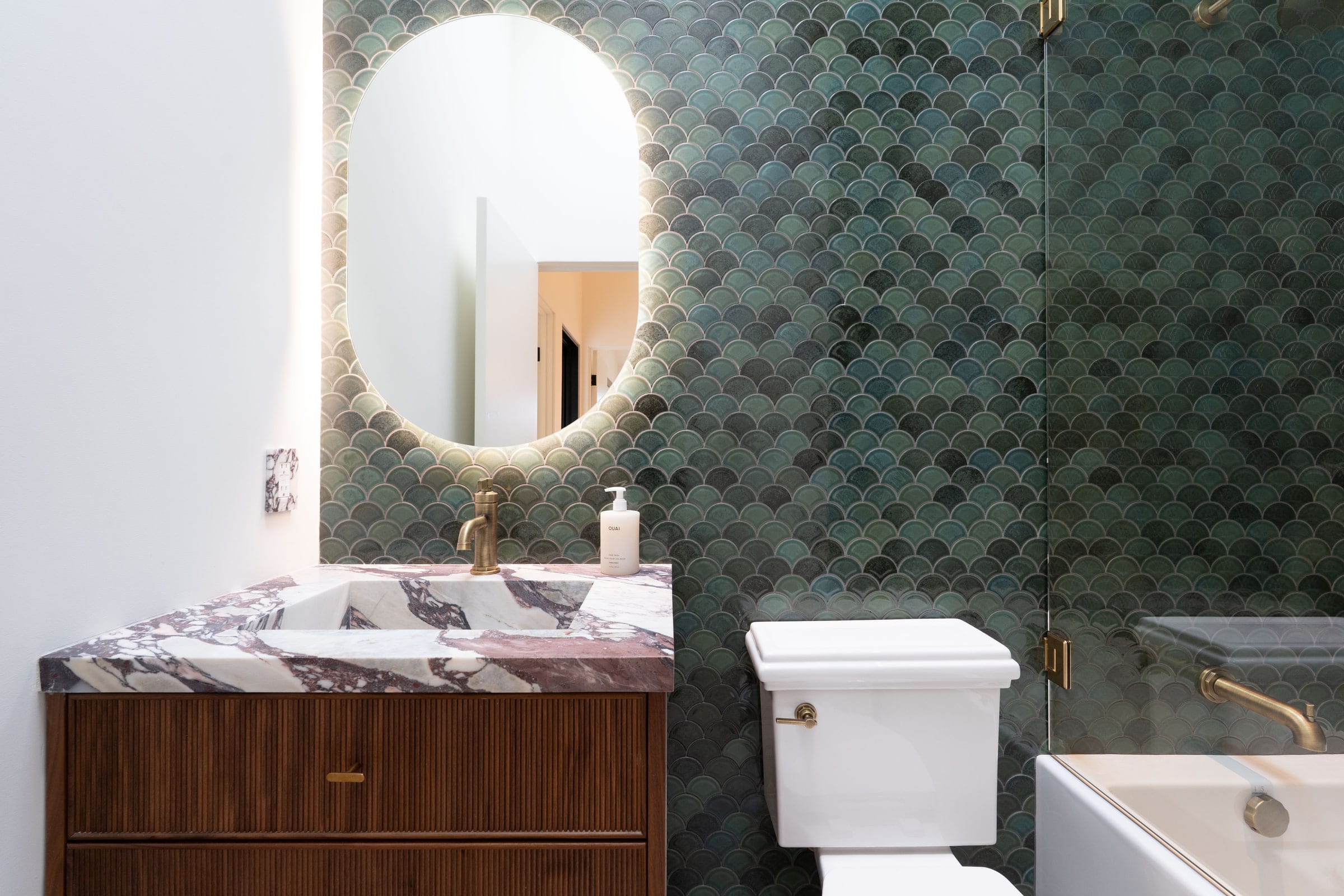 Bathroom with a burgundy-veined marble vanity, fluted wood cabinetry, and a green fish-scale tile shower wall, DHRH Padaro Lane renovation