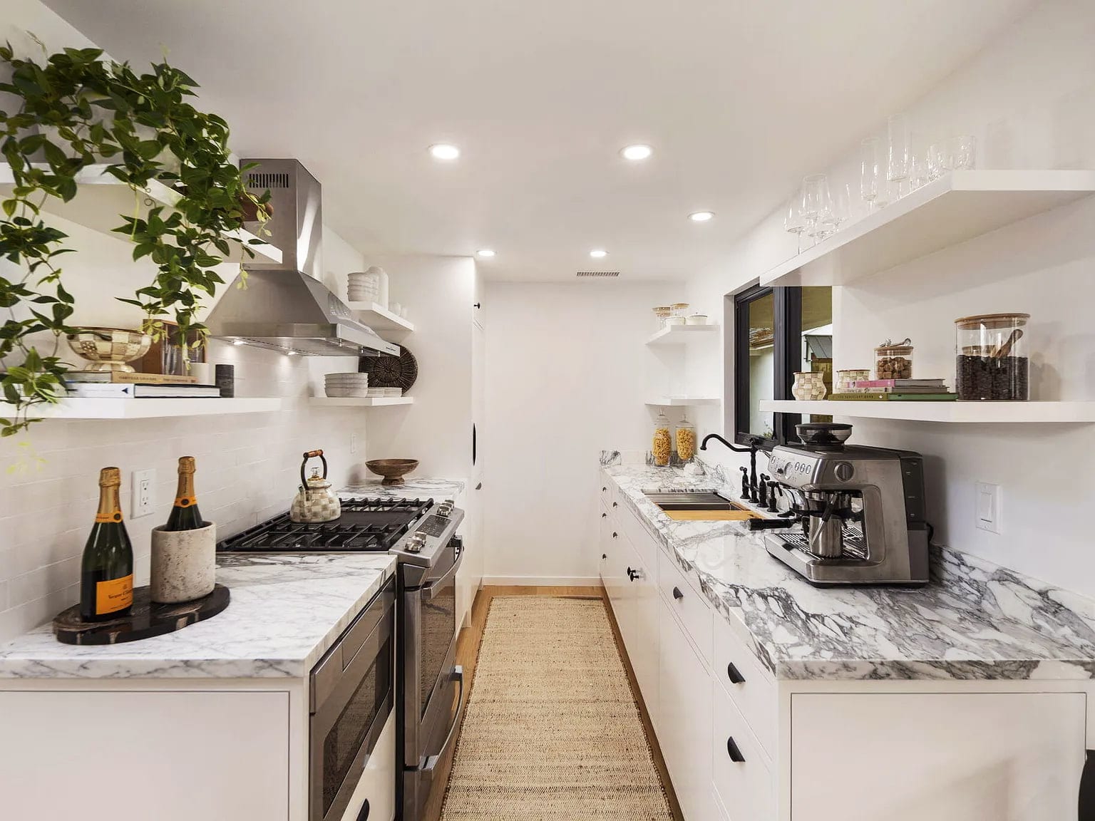 Galley butler's pantry with marble counters, floating shelves, and a built-in espresso machine, DHRH San Roque renovation