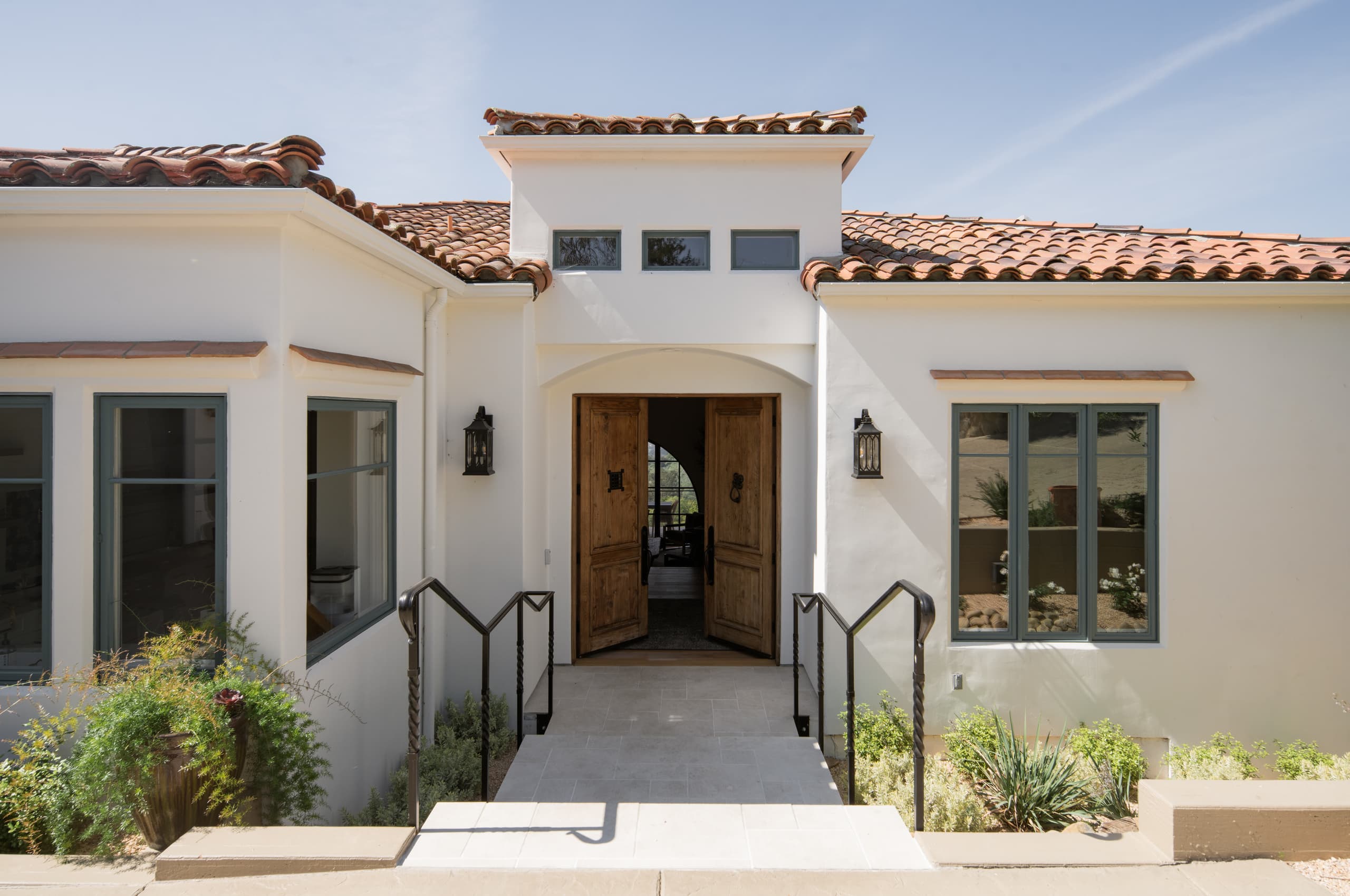 The arched entry and reclaimed wood doors of a DHRH Mission Canyon home